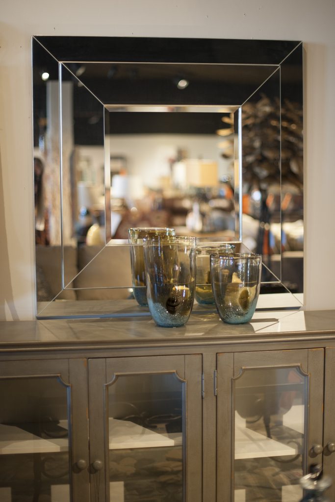 You can gain a new perspective on your room by simply hanging a mirror. Reflecting natural light brightens the room, plus it offers the illusion of more space beyond the wall.